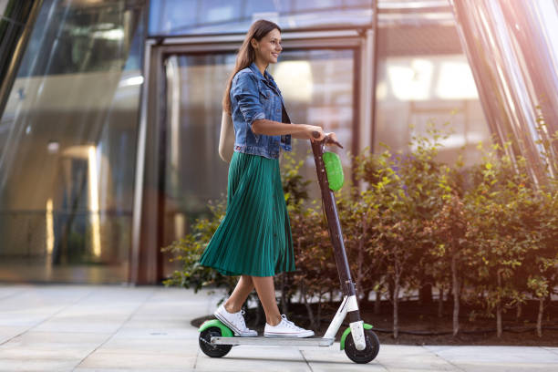 Female commuter riding electric push scooter