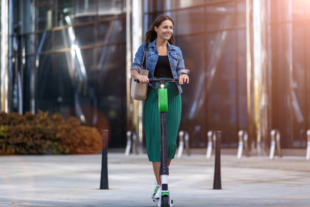 istock Female commuter riding electric push scooter 1177256997