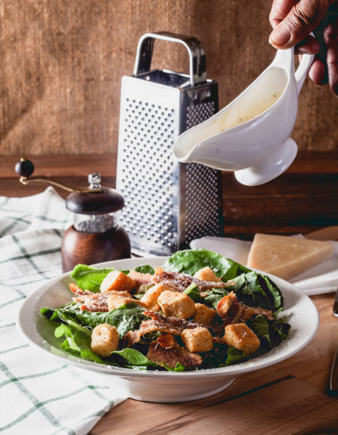 istock Fresh Caesar Salad on a Wooden Table 1177258335