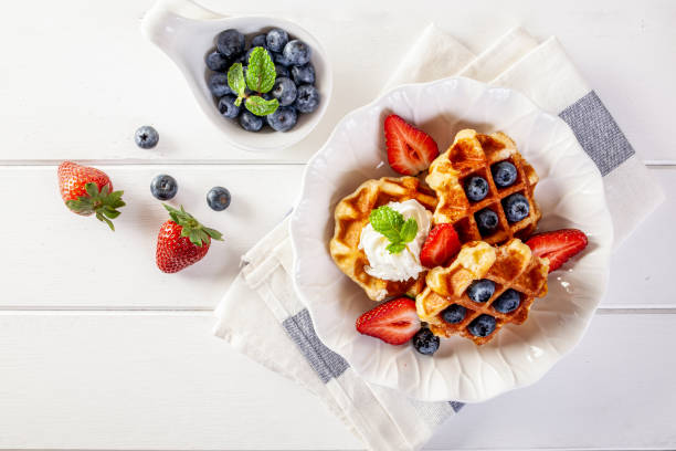istock Strawberry waffles and blueberries with honey for breakfast 1177258443