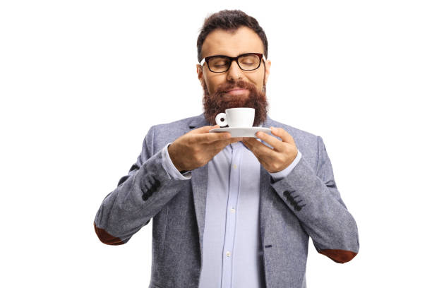 Bearded man smelling a cup of espresso coffee isolated on white background