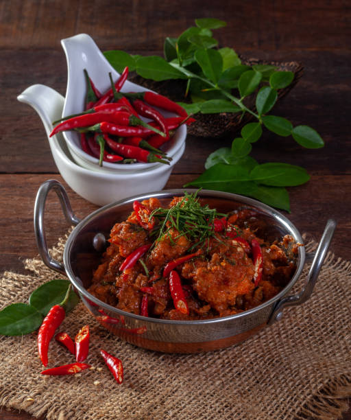 istock Stir fried spicy fish in a pan On a wooden background 1177260124