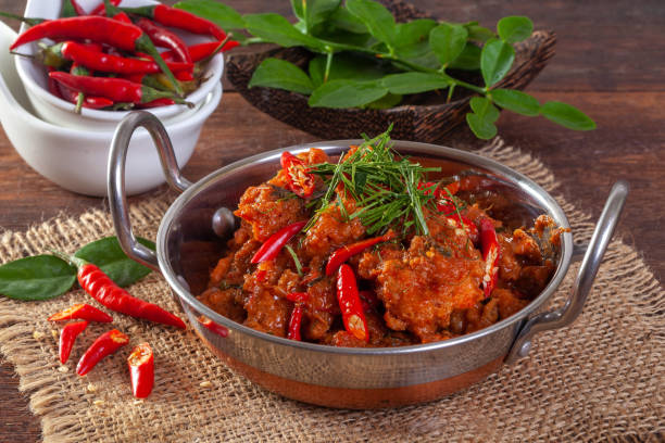 istock Stir fried spicy fish in a pan On a wooden background 1177260142