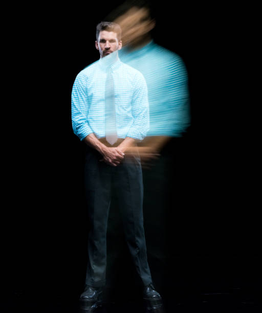 Full length / one man only / one person / front view / looking at camera of 30-39 years old adult handsome people caucasian young men / male businessman / business person standing / multiple exposure / long exposure / blurred motion in front of black background wearing button down shirt / shirt / gingham / necktie / pants / businesswear / a suit who is serious / confidence / concentration / black color longitud completa / un hombre solamente / una persona / vista frontal / mirando a la cámara de 30-39 años adultos guapos personas caucásicas hombres jóvenes / hombres de negocios masculinos / hombre de negocios de pie / exposición múltiple / exposici
