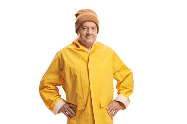 istock Elderly man in a yellow raincoat wearing a warm hat 1177261922