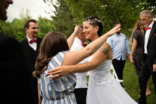 istock Millennial bride hugging friend after wedding outdoors. 1177261979