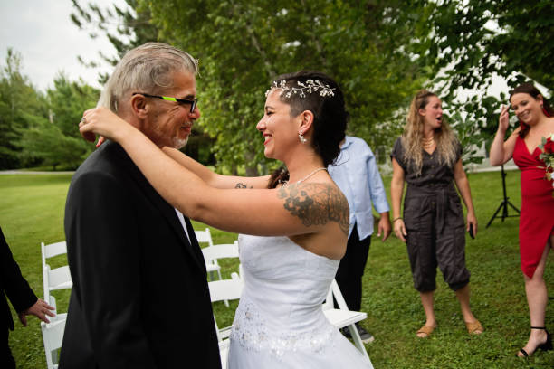 istock Millennial bride hugging father after wedding outdoors. 1177262052