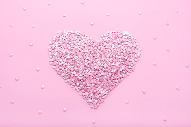 istock Pink background. Pink hearts on a pink background. Hearts sprinkles. 1177262091