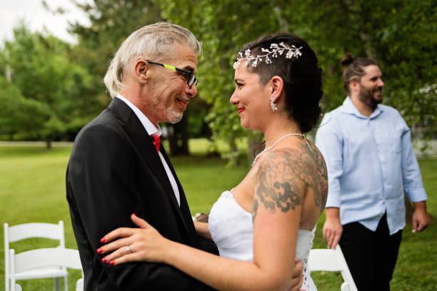 istock Millennial bride hugging father after wedding outdoors. 1177262112