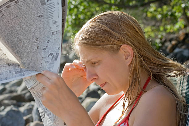 istock Young woman reading newspaper 117726256