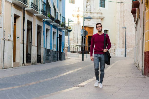 istock Young businessman is walking on the street with his backpack 1177268910