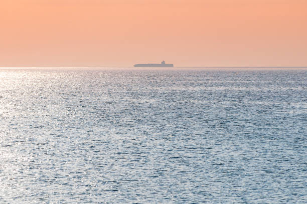 istock Barge at beautiful sunset. Anchorage for ships, copy space. Amazing evening seascape, breathtaking travel view. 1177269401