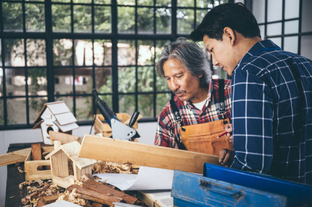 istock Two carpenters working in shop  wood craftsman 1177271050