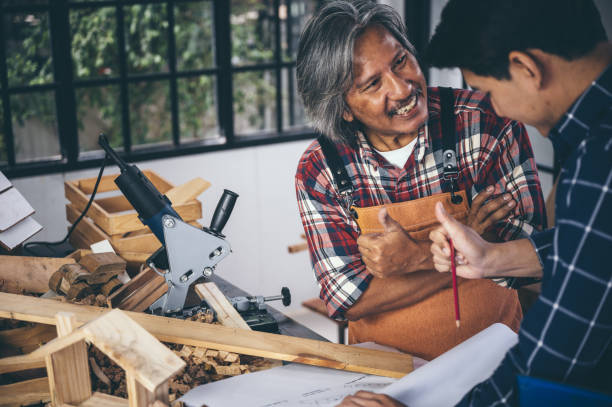 istock Two carpenters working in shop  wood craftsman 1177271056