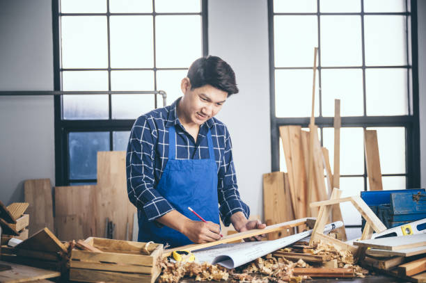 istock Background image of woodworking workshop: carpenters work table with different tools and wood cutting stand, vintage filter image 1177271069