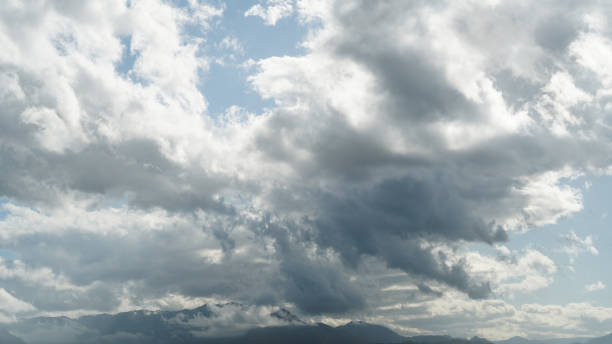 istock Thunderclouds over the tops of the mountains against a clear blue sky in backlight 1177272918