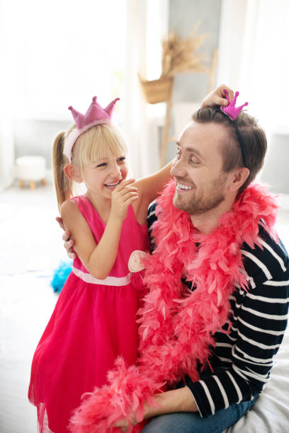 istock Daughter laughing while giving little crown for daddy 1177274386