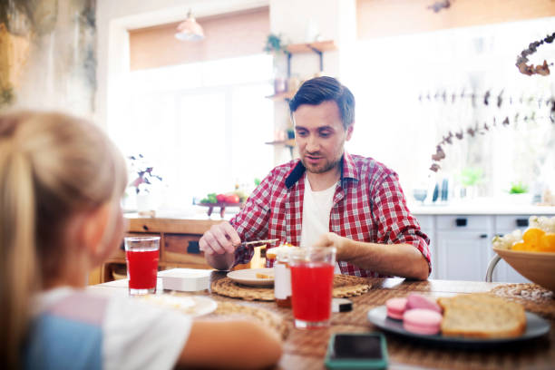 istock Daddy eating breakfast with daughter in the morning 1177275332