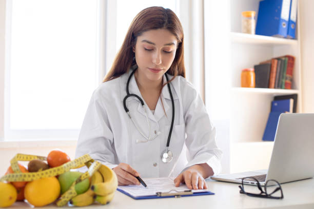 istock Young nutritionist working at desk and writing 1177277629