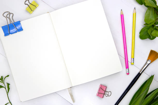 istock Blank page of sketchbook with green leaf and art tools. Creative artistic flat lay with empty spread of notebook 1177279036