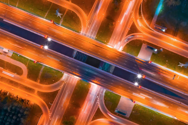 istock Intersection of two major highways, intersection under a bridge, night aerial top view of street lighting. 1177279699
