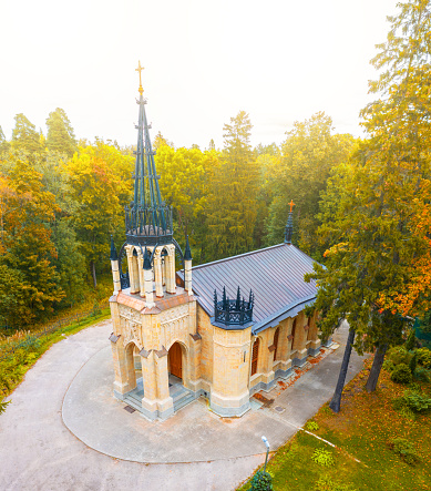 Gothic church in autumn park, aerial view