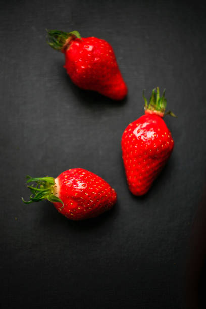 istock Delicious strawberries on black background 1177280382