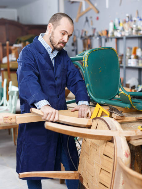istock Carpenter repairing antique chair 1177280556