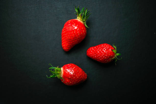 istock Delicious strawberries on black background 1177280635