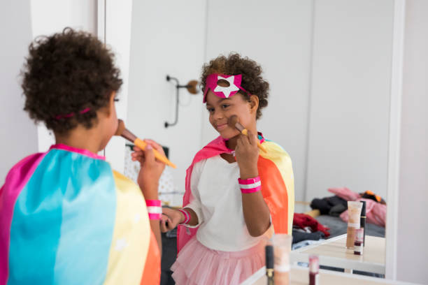Cute girl wearing a costume looks in the mirror