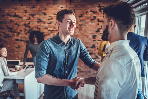 istock two businessmen shaking hands in office 1177284027