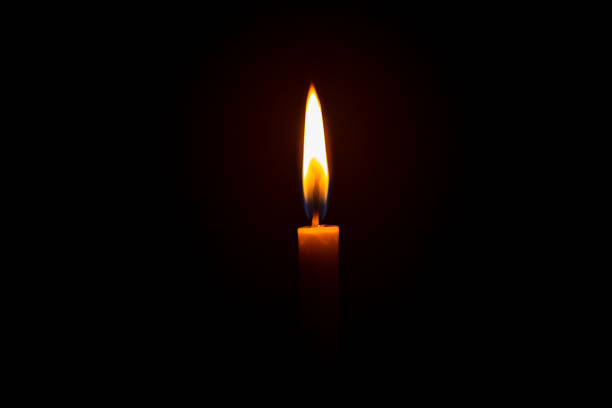 istock Candle light on black background ,Single lit candle with quite flame 1177285476