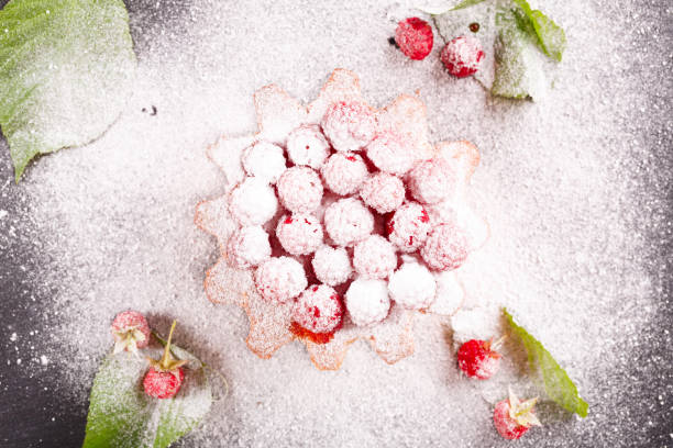 istock muffin decorated with fresh raspberries on a black plate. 1177285518