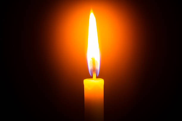 istock Candle light on black background ,Single lit candle with quite flame 1177286679