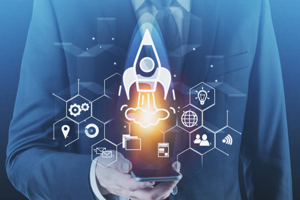 istock Businessman looking at phone, startup rocket 1177290106