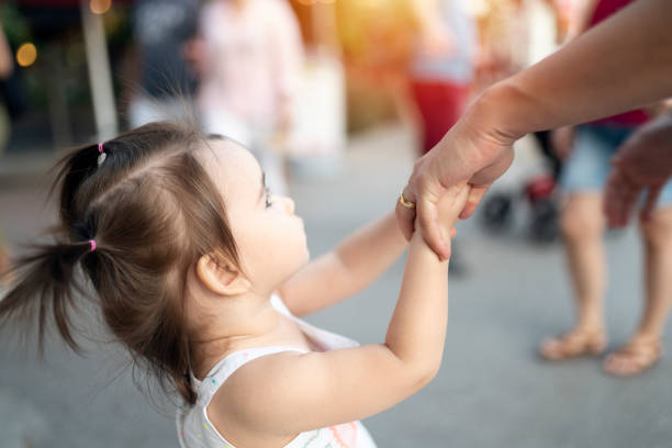 istock Mother and daughter holding hands 1177290238