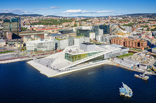 Oslo, Norway - September 21, 2019: Oslo Cityscape Aerial View of Harbor Waterfront with Operahuset - the famous Opera House in the foreground on a sunny day. Drone point of view to the cityscape horizon. Oslo, Norway, Scandinavia
