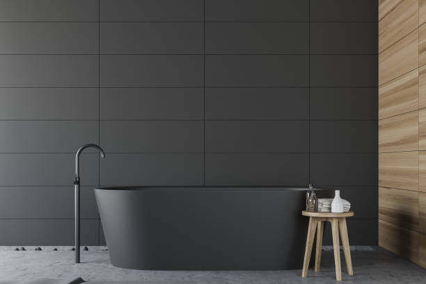 istock Gray tile and wood bathroom with tub 1177291209