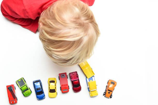 jongen speelt met speelgoed auto's thuis hoge hoek uitzicht vanaf direct boven het kind - speelgoedauto stockfoto's en -beelden