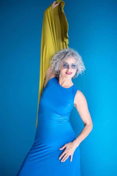 istock Good-looking mature lady wearing long blue dress posing 1177291788