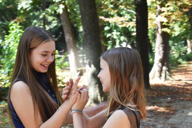 istock Two sister in the park, holding hands. 1177292859