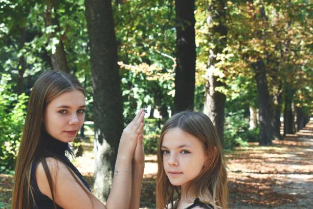 istock Two sister in the park, holding hands. 1177297583