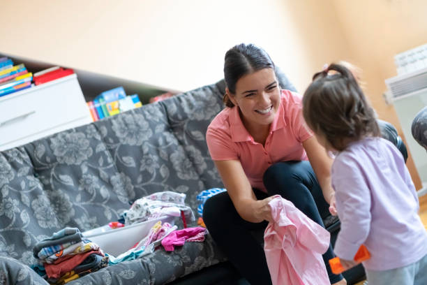 istock Mother and little daughter doing laundry at home 1177303185