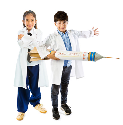 Young boy and girl poses as rocket scientists. Concept photo of gender equality, and career aspiration.