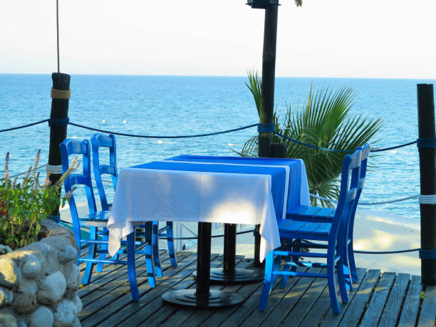 istock Romantic table for two in the restaurant on sea background 1177307370