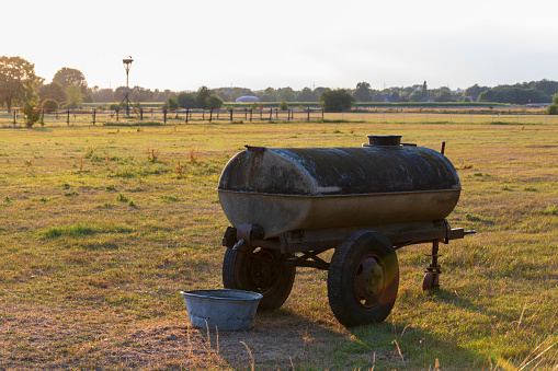 Water tank and zinc tub on a pasture
