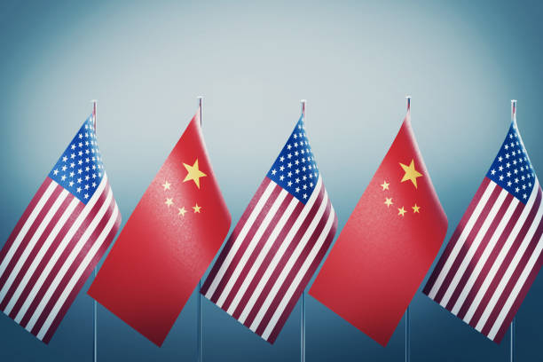 American and Chinese flags in a row on grey background. Horizontal composition with copy space and selective focus. Great use for American and Chinese politics.