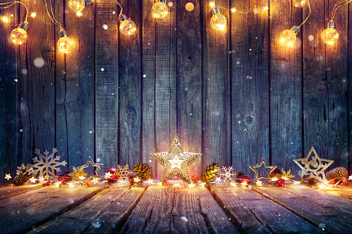 Christmas Decoration With Stars And String Lights On Rustic Wooden Table