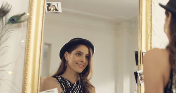 istock Seductive brunette trying on a bowler hat 1177315312