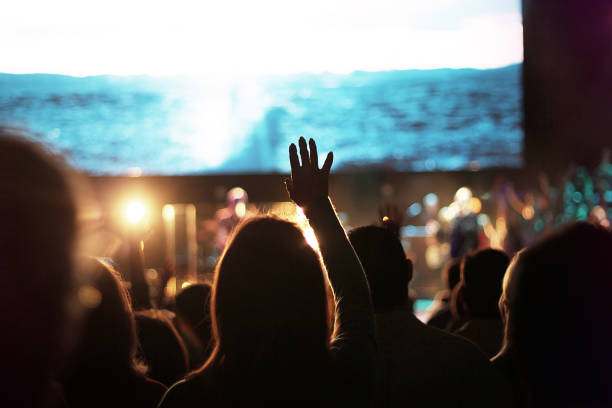 Church Worship Crowd crowd worship worshipping worshipper church Sunday hand hand up hands up sing singing choir easter concert production band music song songs sing singing hand raised photos stock pictures, royalty-free photos & images